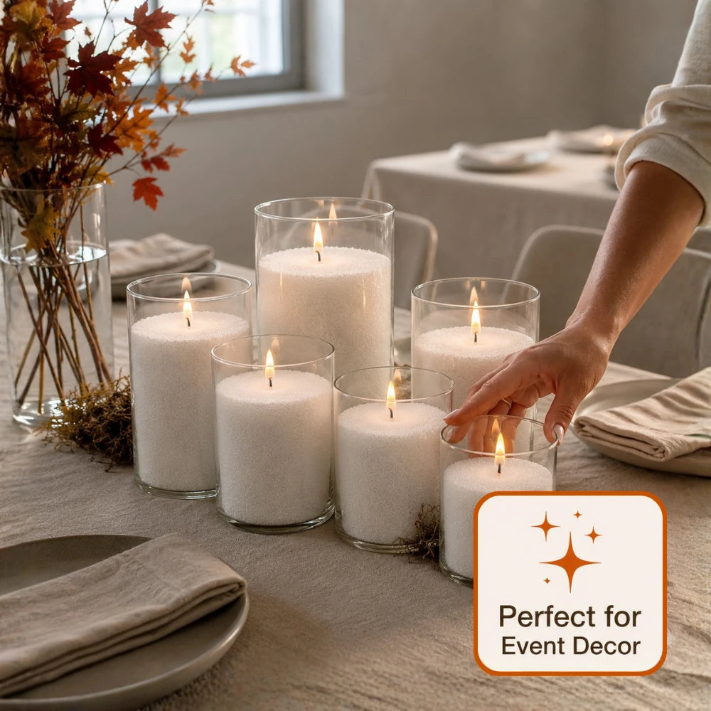 Warmnest pearled candles in glass cylinders styled along an autumn event table with linen and dried foliage