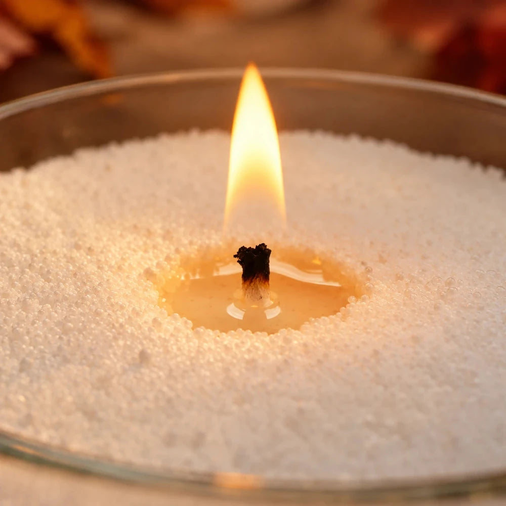 Close up of a single flame and its melt pool in fine white Warmnest wax sand