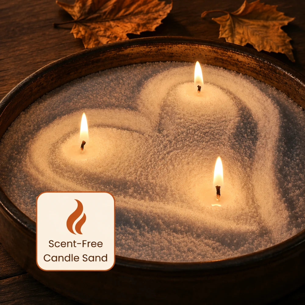 Scent-free Warmnest candle sand shaped into a heart with three lit wicks in a dark wooden bowl